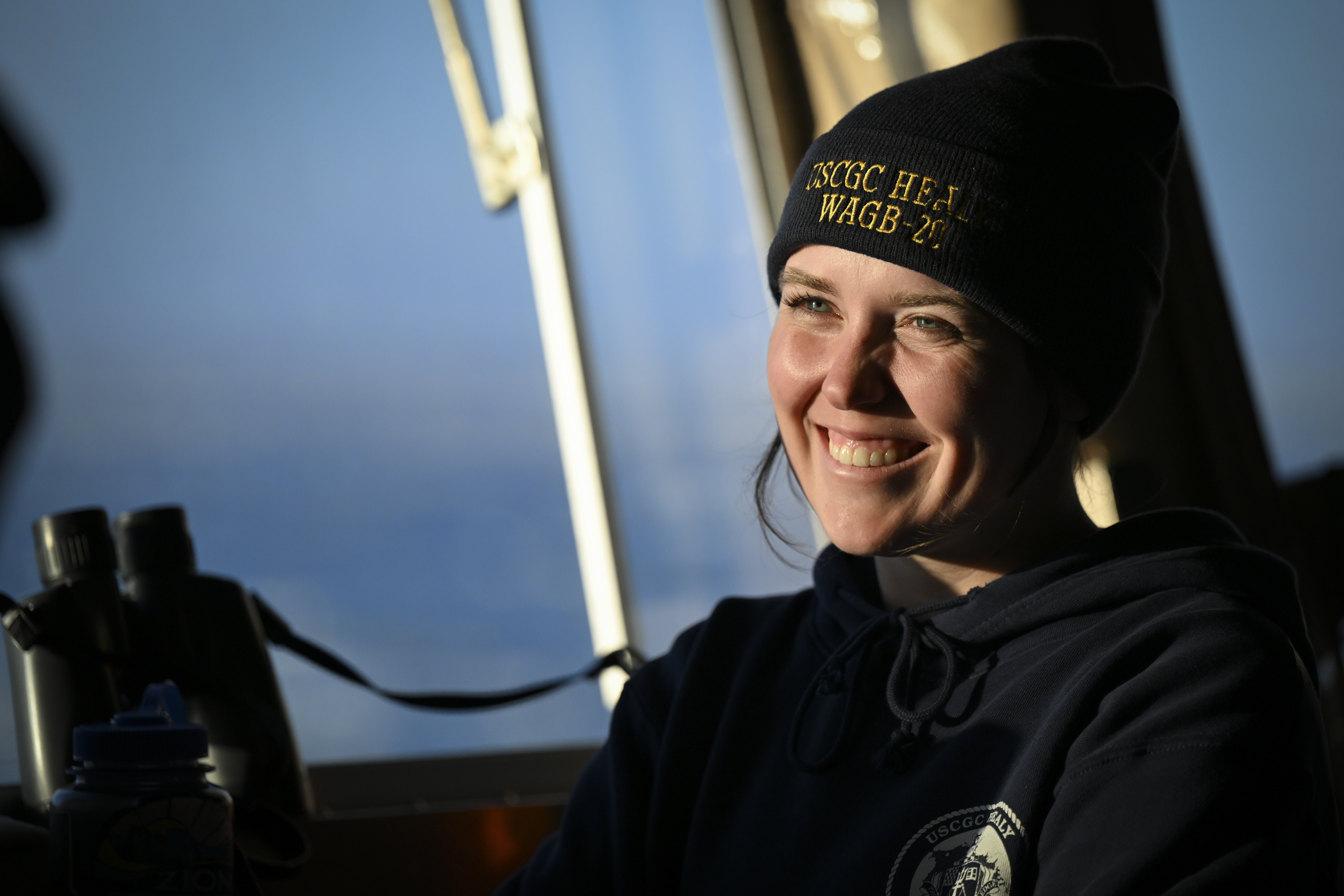 Seaman Sarah Treacy stands watch on navigation bridge of Coast Guard Cutter Healy as cutter transits Chukchi Sea, June 30, 2025 (U.S. Coast Guard/Steve Strohmaier)